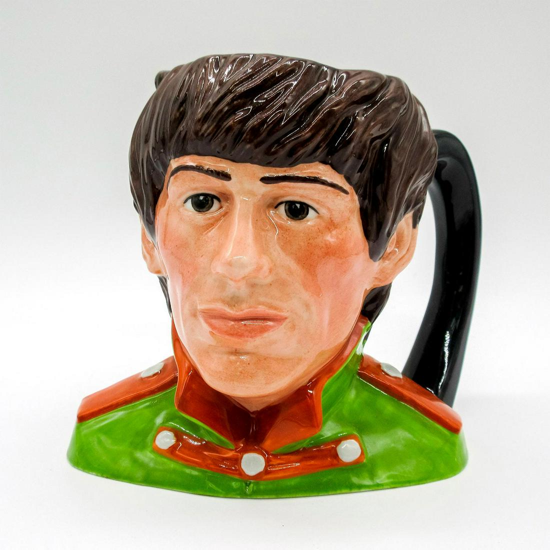 George Harrison D6727 - Odd Size - Royal Doulton Character Jug: Green tunic; orange collar and epaulettes. George Harrison (1943 - 2001) played guitar and wrote songs for the Beatles. Upon the breakup of the group, Harrison pursued a successful solo career until h
