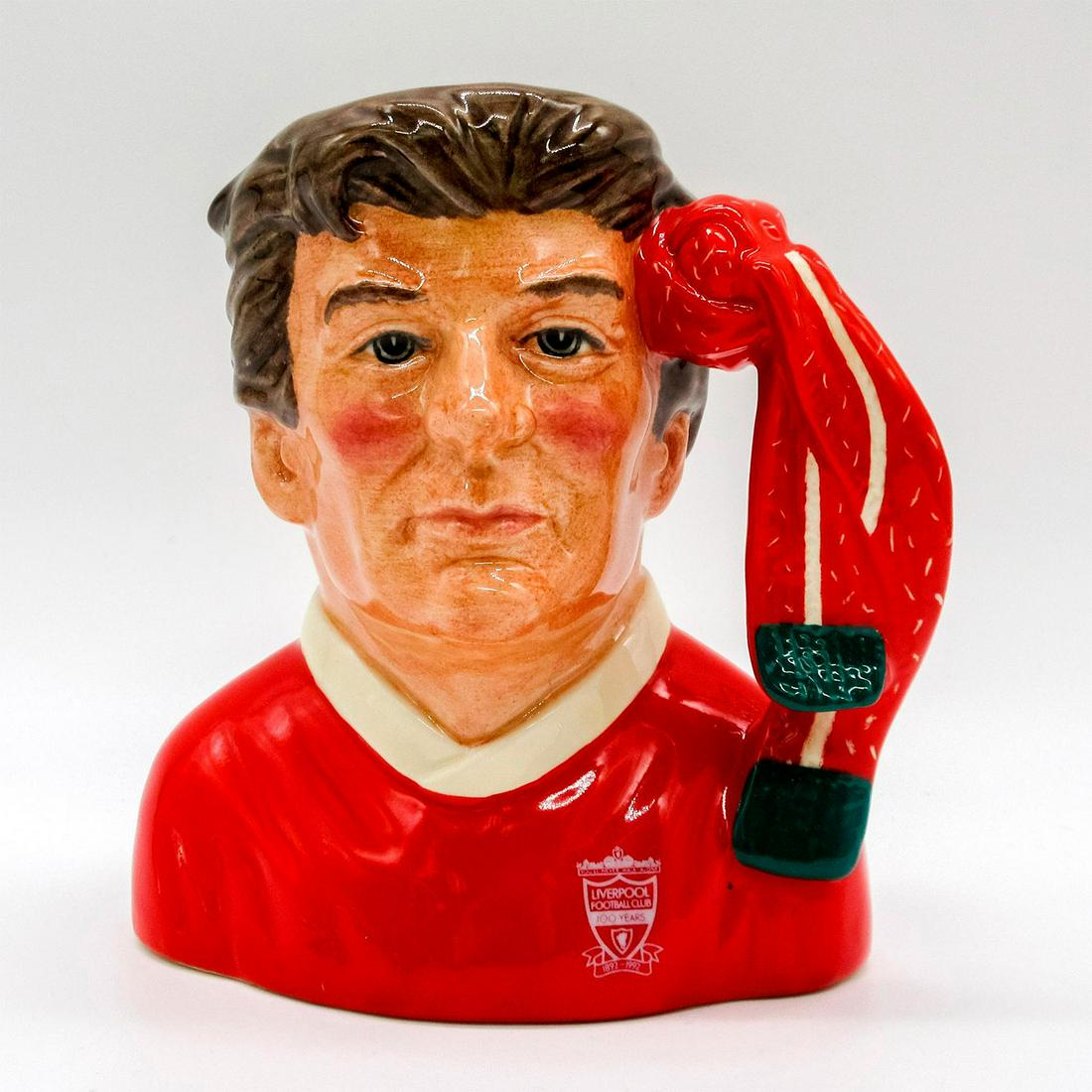 Liverpool Football Club Supporter D6930 - Small - Royal Doulton Character Jug: Red and white uniform. Series: The Football Supporters. Royal Doulton backstamp. Artist: Stanley J. Taylor Issued: 1992 - 1999 Dimensions: 5"H Manufacturer: Royal Doulton Country of Origin: England