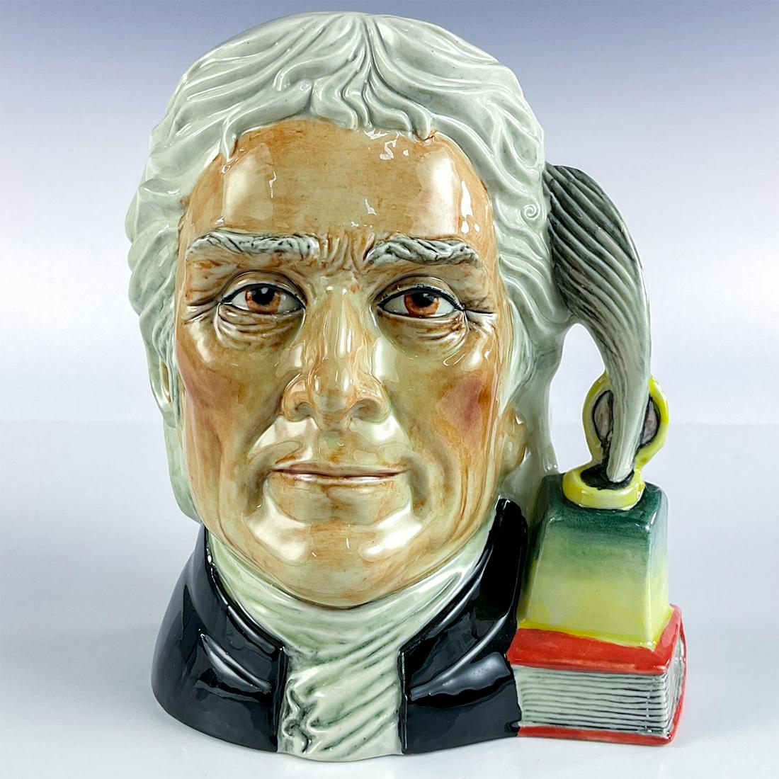 Vintage Pascoe & Company Character Jug, Thomas Jefferson: 3rd Issue. Part of The American Patriot Series. Glossy finish. Depicted with book and inkwell handle. Pascoe & Company backstamp. Hand modeled and hand painted. Dimensions: 6.75"H Edition Number: 4/25