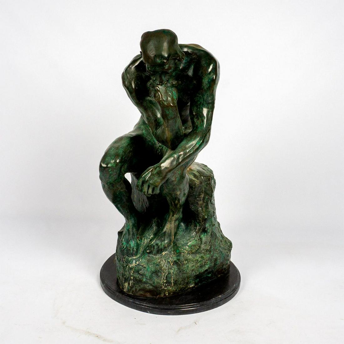 After Auguste Rodin (French, 1840-1917) Large Bronze Sculpture: Impressionist style bronze sculpture depicting a nude man seated and hunched over in a state of deep thought. Modeled after Auguste Rodin's piece Le Penseur (The Thinker). Heavy green patination. Roun