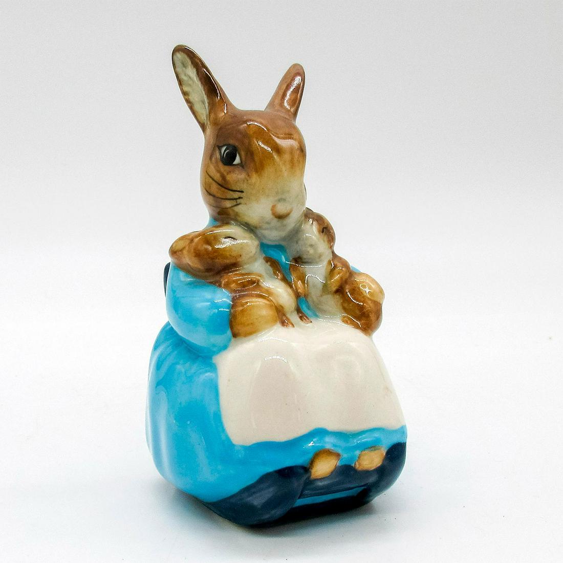Mrs. Rabbit and Bunnies - Beswick - Beatrix Potter Figurine: Brown bunny dressed in light blue dress with white apron rocking baby bunnies to sleep. Beswick backstamp. This item has no reserve. Issued: 1976 Dimensions: 3.5" H Manufacturer: Beswick Country of Or
