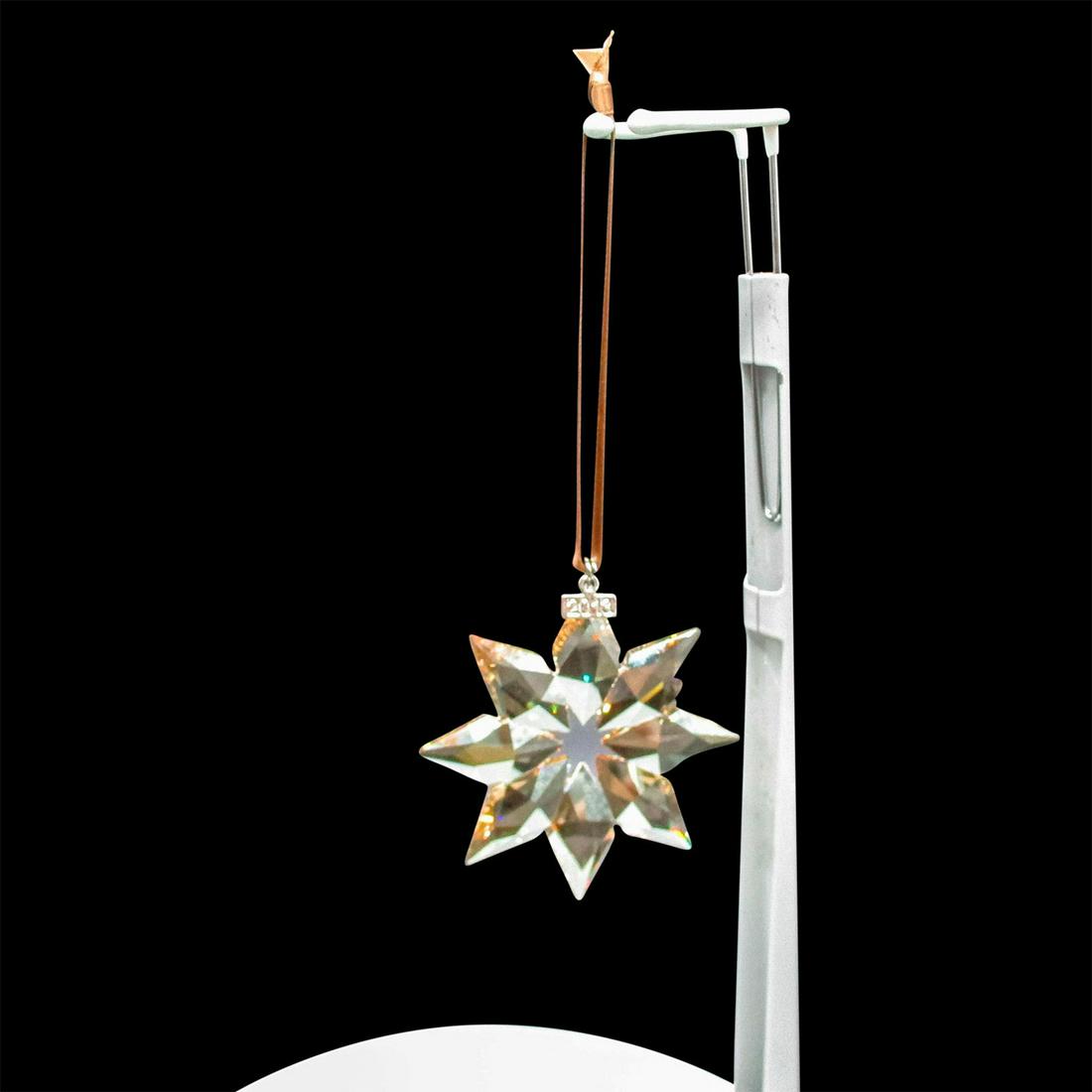 Swarovski Crystal 2013 Holiday Ornament: Lead crystal limited edition annual Christmas snowflake with 2013 tag on ornament and satin ribbon. Swarovski etched backstamp. Includes original box: 6"L x 4"W x 1"H. Issued: 2013 Dimensions: 1.25" L
