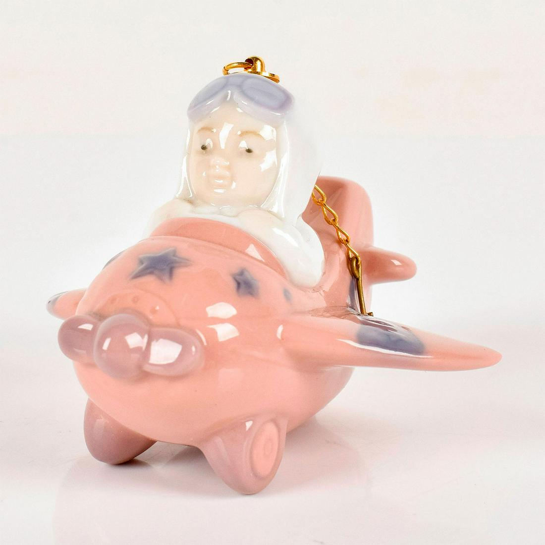 Little Aviator 1006343 - Lladro Porcelain Figurine: Glossy finish, Lladro backstamp. Artist: Jose Javier Malavia Issued: 1996-1997 Dimensions: 2"H x 2.75"W Manufacturer: Lladro Country of Origin: Spain