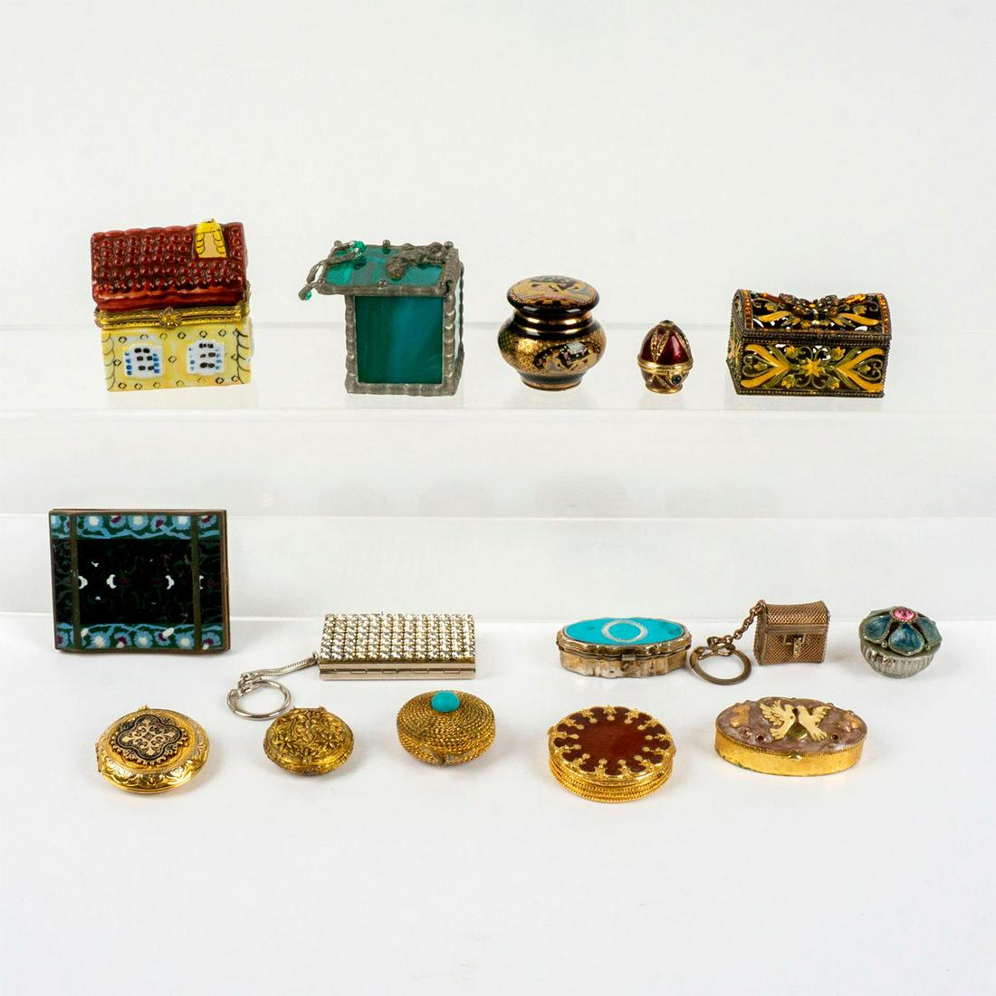 15pc Vintage Trinket Boxes and Compacts: Colorful and ornate metal, ceramic and glass trinket boxes, cosmetic compacts and two keychains. The largest compact has two compartments, a mirror and is 3"L x 2.25"W. The largest house shaped trinke