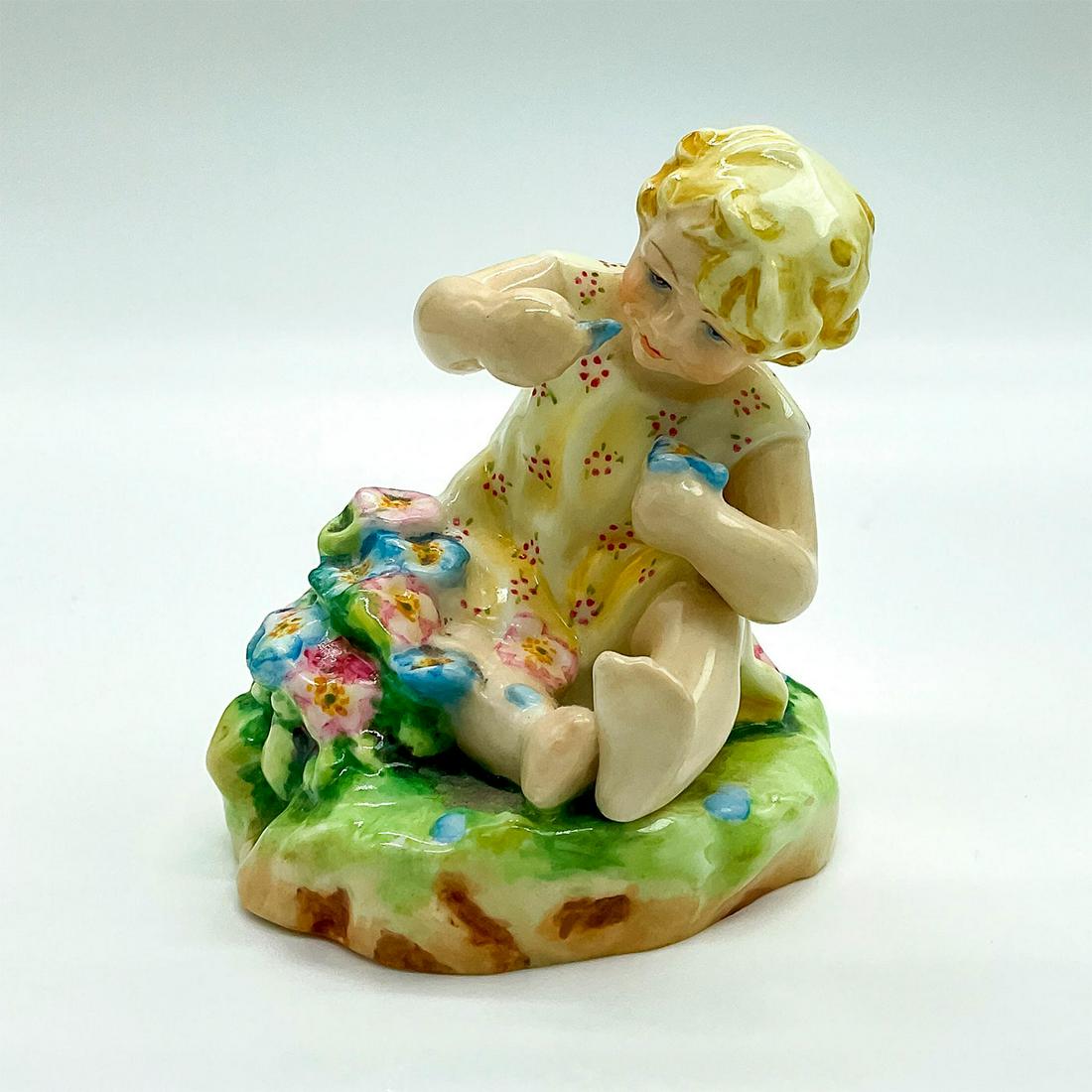 Royal Worcester Figurine, Mischief 2914: Hand painted fine bone china depicting a young girl playing with flowers. Royal Worcester backstamp. Artist: F. G. Doughty Issued: 20th c. Dimensions: 2.25"W x 3.25"H Manufacturer: Royal Worcester Cou