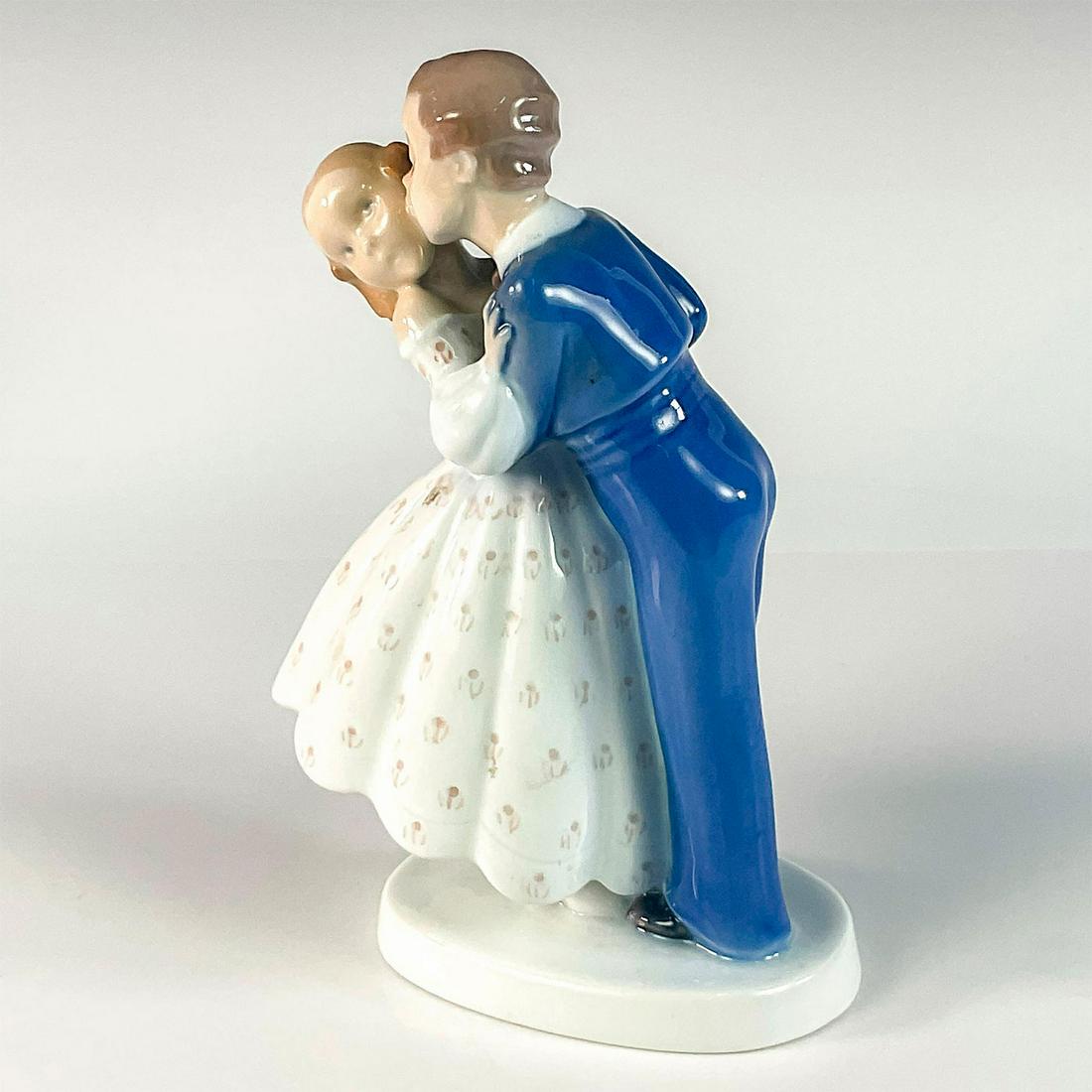 Vintage Bing & Grondahl Figurine, Youthful Boldness 2162: Glossy finish. Depicts boy stealing a kiss from a girl. B&G backstamp. Dimensions: 5"L x 3"W x 7.5"H Manufacturer: Bing & Grondahl Country of Origin: Denmark