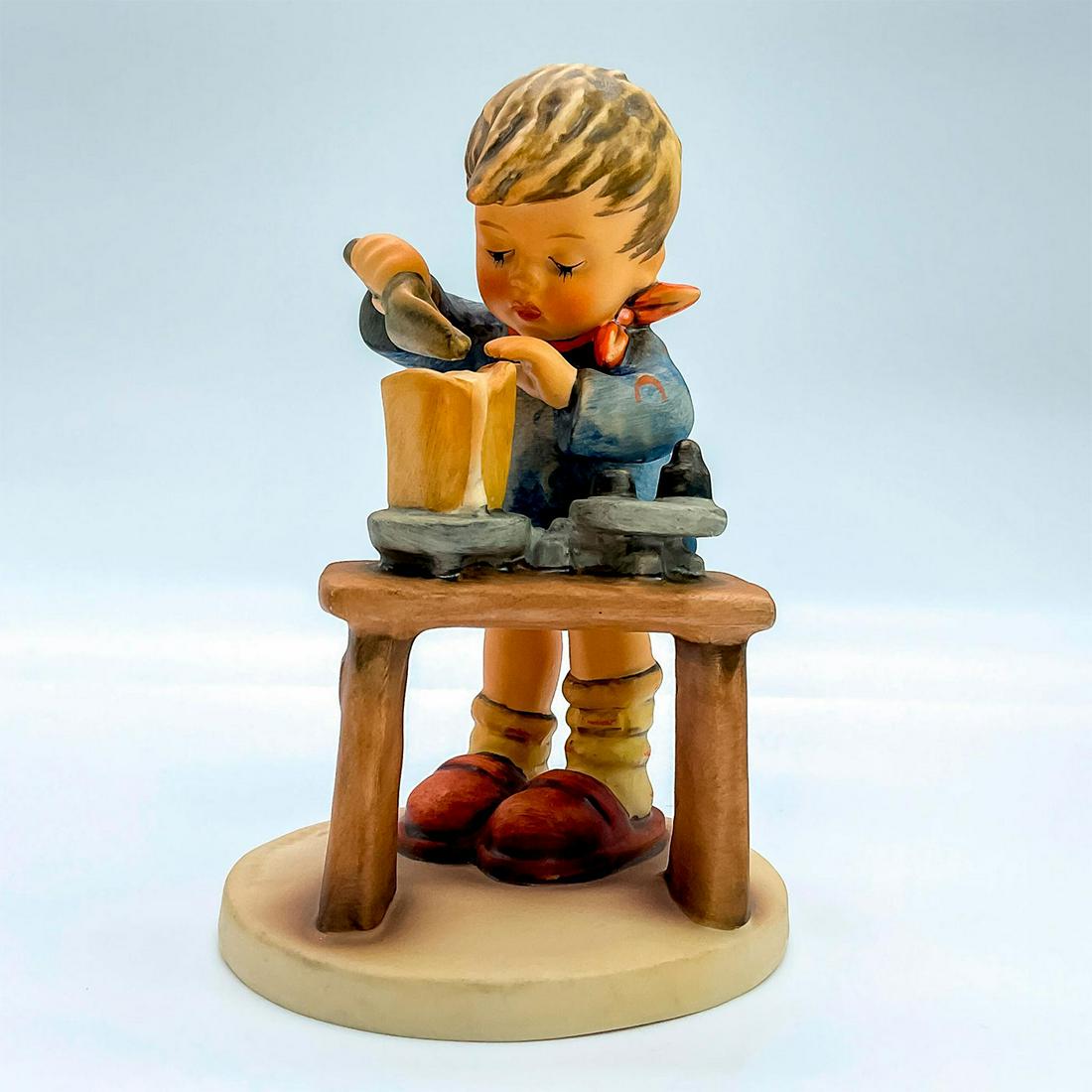 Goebel Hummel Figurine, A Fair Measure: Porcelain hand painted in matte finish. Goebel backstamp. Impressed M. I. Hummel to round base. Artist: M. I. Hummel Issued: 1972 Dimensions: 2.75"W x 6"H x 3.75"Dia. Manufacturer: Goebel Hummel Count