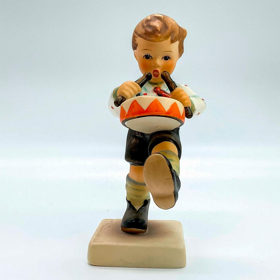 Goebel Hummel Figurine, Little Drummer: Porcelain hand painted in matte finish. Goebel backstamp. Impressed M. I. Hummel to square base. Artist: M. I. Hummel Issued: 1955 Dimensions: 1.75"L x 2"W x 4.25"H Manufacturer: Goebel Hummel Country