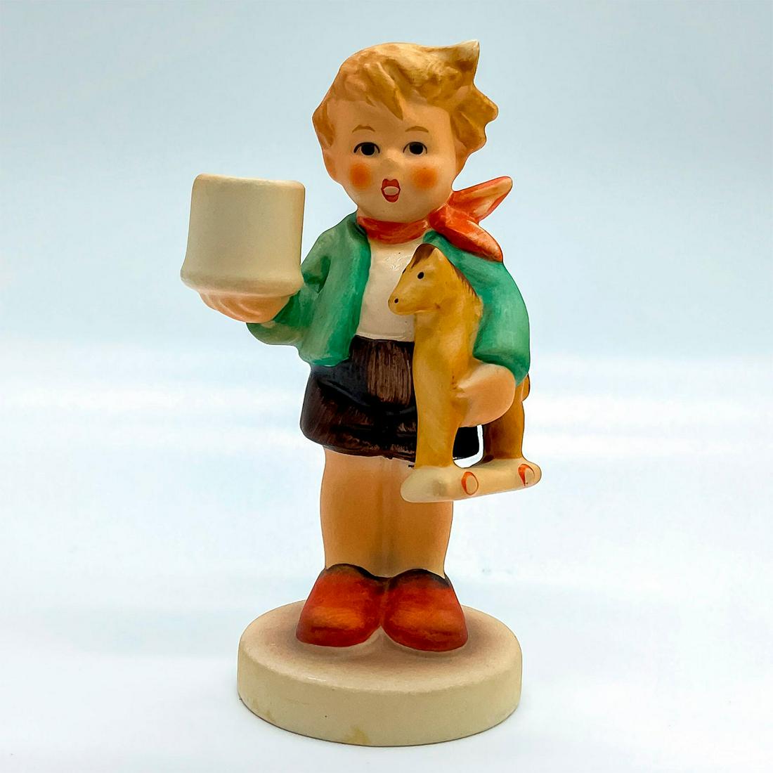 Goebel Hummel Candleholder Figurine, Boy With Horse: Porcelain hand painted in matte finish. Goebel backstamp. Impressed M. I. Hummel to round base. Artist: M. I. Hummel Issued: 20th c. Dimensions: 2"W x 3.75"H x 1.75"Dia. Manufacturer: Goebel Hummel Co