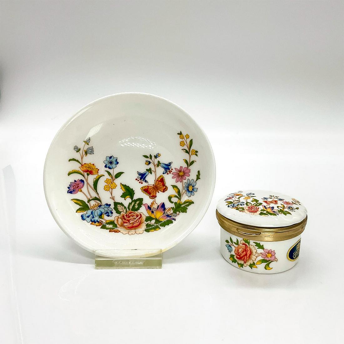 2pc Aynsley Cottage Garden, Trinket Dish and Hinged Box: Fine bone china with colorful floral pattern with a butterfly; portrayal of an english garden. Aynsley backstamp and factory label. Dish measures: 4.5 in D. Box measures: 1.5 in. H. This item has no r