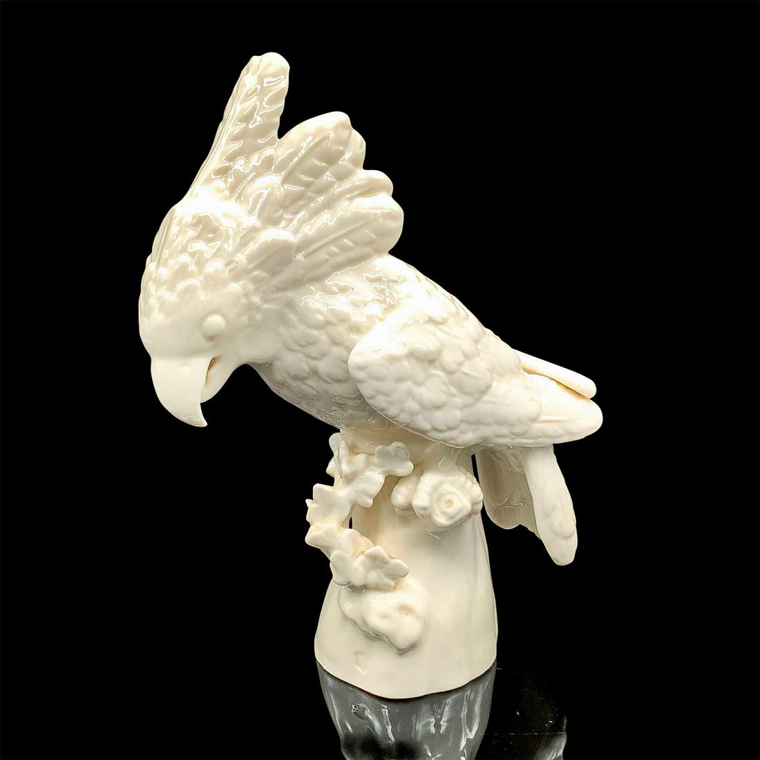 Antique Nymphenburg Cockatoo Figurine: Glossy finish in cream coloration. Depicts bird perched on a tree branch. Nymphenburg backstamp. Dimensions: 3"L x 5.75"W x 7.5"H Manufacturer: Nymphenburg Country of Origin: Germany
