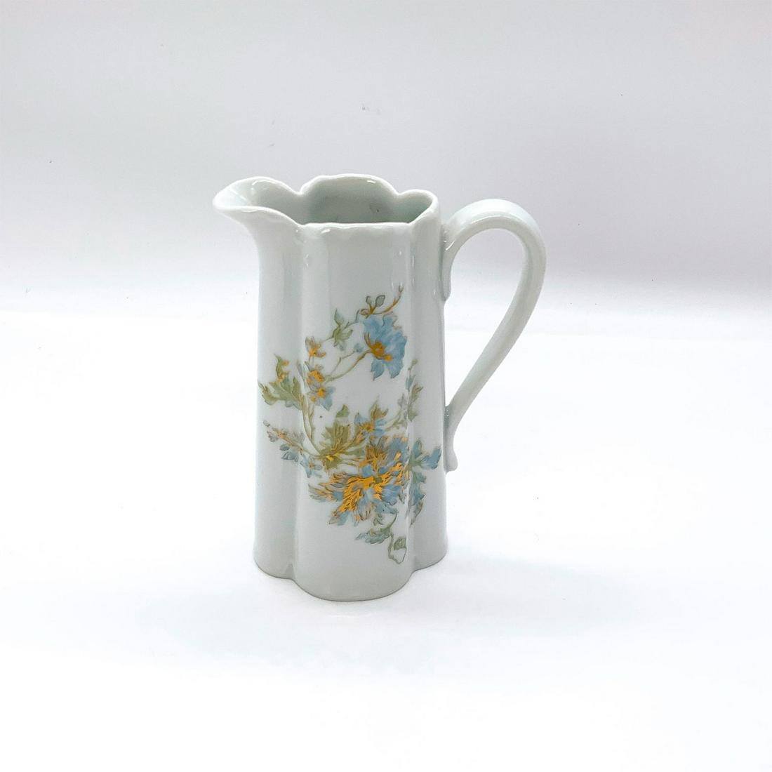 Haviland Limoges Porcelain Creamer: Elegantly decorated in blue flower pattern with gold accents. Haviland Limoges backstamp. Signed by Frederick Haviland. Issued: 20th c. Dimensions: 3.75"L x 2.25"W x 5.25"H Manufacturer: Haviland Limo