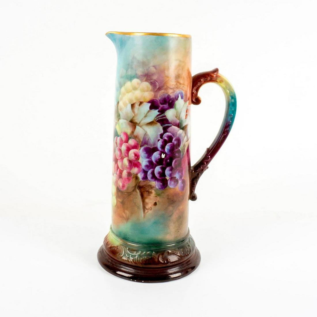 Antique R Delinieres and Co Limoges Wine Pitcher: Beautifully hand painted with grape vine design. Gold trim to rim. Delinieres and Co. backstamp. Dimensions: 7.5"L x 6.25"W x 13.5"H Manufacturer: R. Delinieres and Co. Country of Origin: France