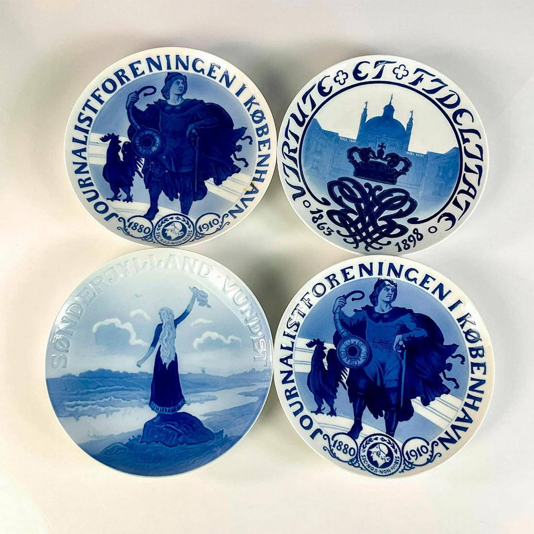 4pc Bing and Grondahl Porcelain Memorial Wall Plates: Pair of 1880-1910 Journalists Memorial plates, 1863-1906 King Christian lX, and 1919 Sonderjylland vundet plates. Blue and white plates. Depth: 1in. Bing and Grondahl backstamps. Artist: Hans Tegner a