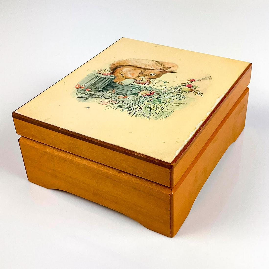 Schmid Wooden Music Box, The Tale Of Squirrel Nutkin: Beatrix Potter Collection. Plush interior. Plays "Waltz Of The Flowers" tune. Schmid backstamp. Dimensions: 5.25" L x 2.25" H Manufacturer: Schmid