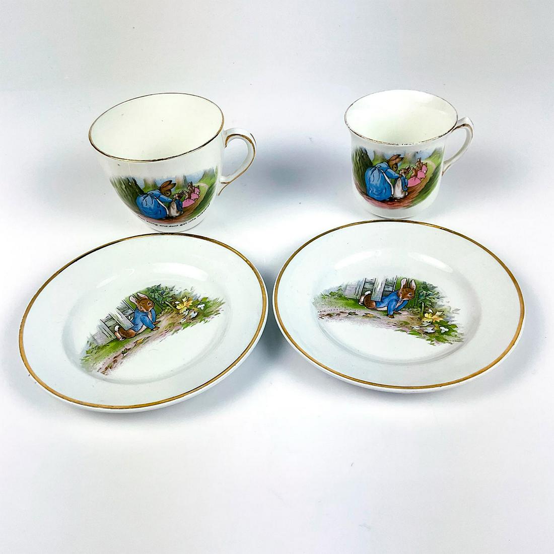 4pc Grimwades Beatrix Potter, Peter Rabbit Teacup set: Includes 2 teacups and 2 saucers with gold rim and illustrations from the Tale of Peter Rabbit. Grimwades and F. W & Co. backstamps. Saucers measure: 5"W. Smallest teacup measures: 3"W x 2.5"H. 3.75"W