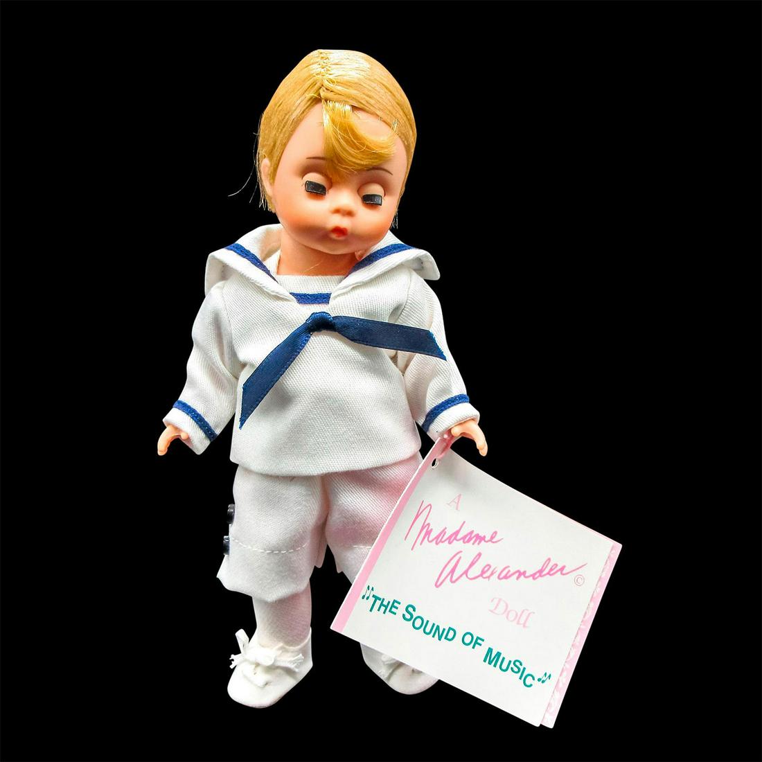 Vintage Madame Alexander Doll, Kurt: Part of the Sound of Music Series. Dressed in white shorts and shirt with blue trim and white shoes. Madame Alexander backstamp on back. Dimensions: 7.5" H Manufacturer: Madame Alexander Country of Or