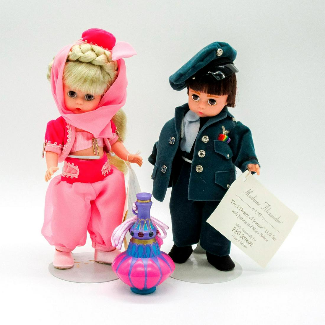 2pc Vintage Madame Alexander Dolls, Jeannie & Major Nelson: Limited Edition. FAO Schwarz Exclusive. Features characters from the "I Dream of Jeannie" television show. Jeannie is dressed in pink outfit. Major Nelson is dressed in blue suit. Madame Alexander bac