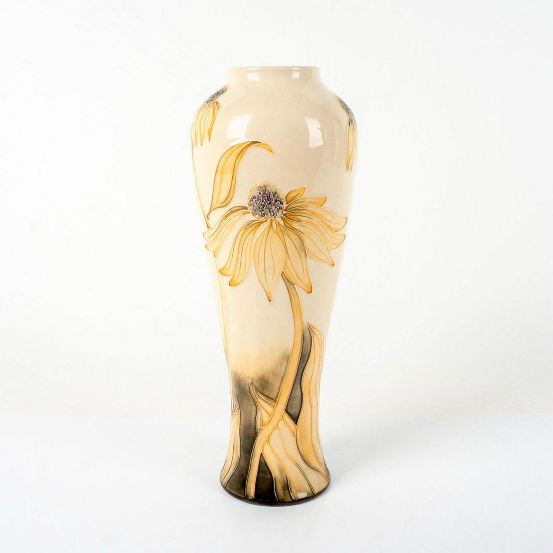 Moorcroft Pottery Vase, Coneflower: Slender ovoid tall vessel with all over ivory glaze, tubeline decorated with long stemmed flowers and black glazes. Moorcroft Made in England impressed. Artist marked to base. Artist: Anji Davenport I