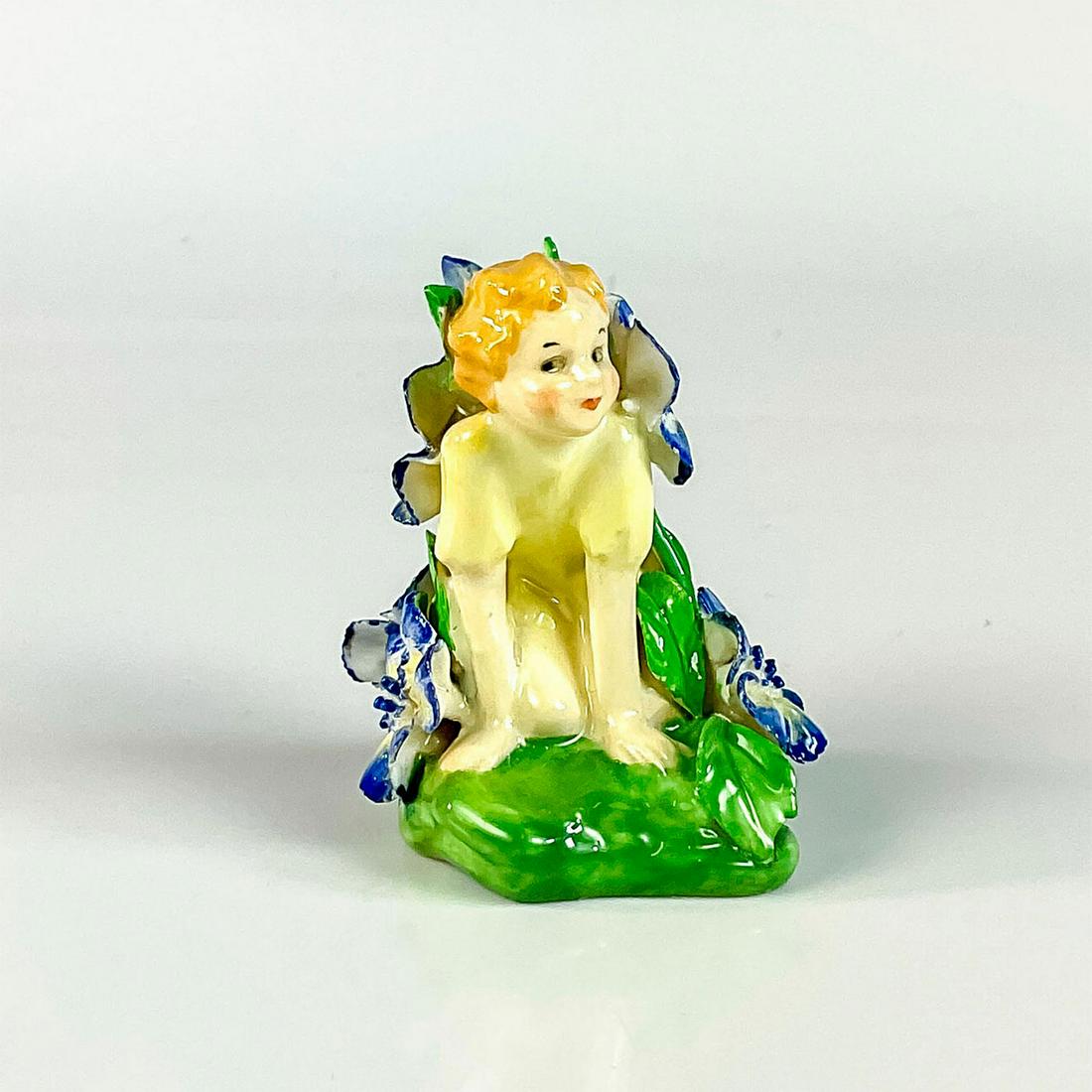 Fairy HN1379 - Royal Doulton Figurine: Fairy surrounded by delicately sculpted blue and white flowers. Glazed porcelain, Doulton England backstamp. Artist: Leslie Harradine Issued: 1930-1938 Dimensions: 1.75"L x 2"W x 2.5"H Manufacturer: D