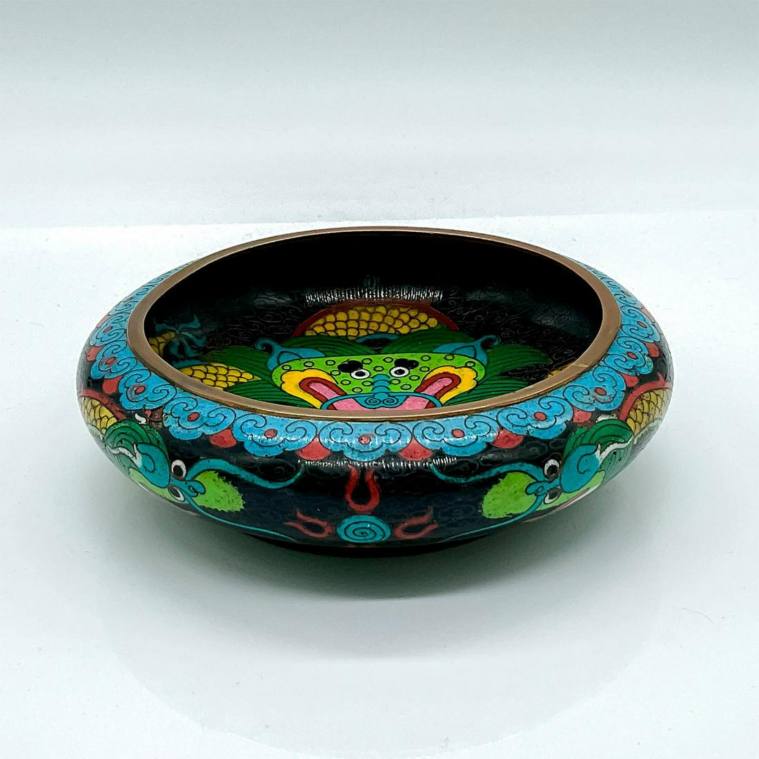 Chinese Cloisonne Dragon Bowl: A beautiful brass enamelware with a two dragons on the exterior fighting over a pearl, and a dragon protecting a pearl in the interior. Dimensions: 1.75"H x 5.5"Dia. Country of Origin: China