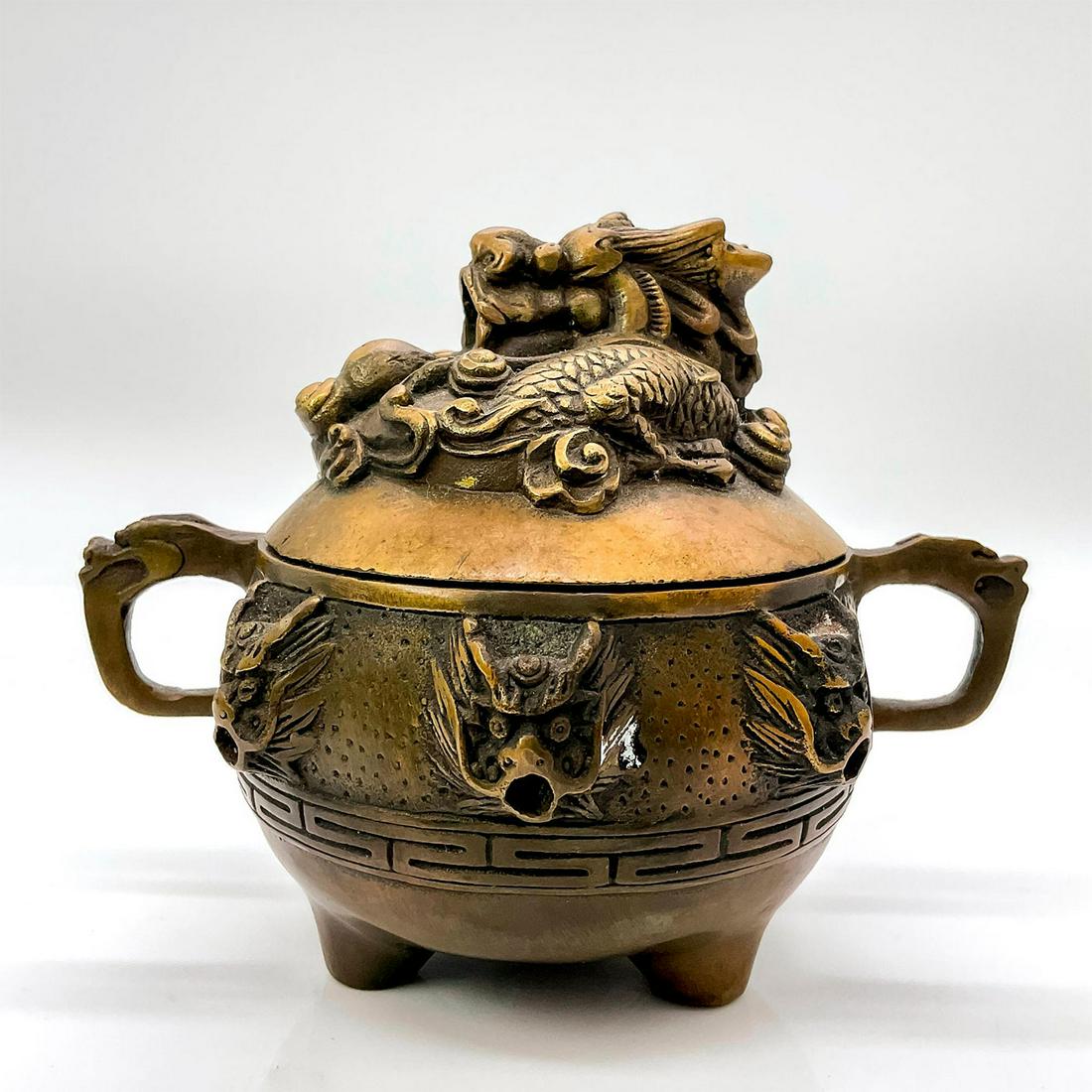 Vintage Chinese Brass Lidded Censer Pot: Mesmerizing double handled incense burner with a large highly detailed Chinese dragon on lid followed by smaller dragons around body of pot. Chinese character marks impressed to bottom. Issued: Early 