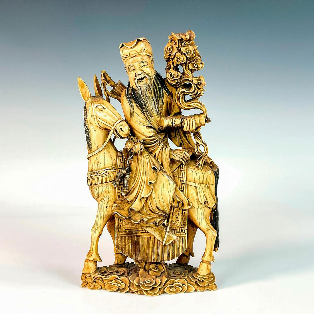 Chinese Ink Carved Resin Sculpture of Zhang Guolao: A beautiful and impressive carving of the one of the Eight Immortals. Zhang Guolao is a symbol of longevity and is often depicted riding a mule or donkey. Dimensions: 6"L x 2"W x 10.25"H Country of Or