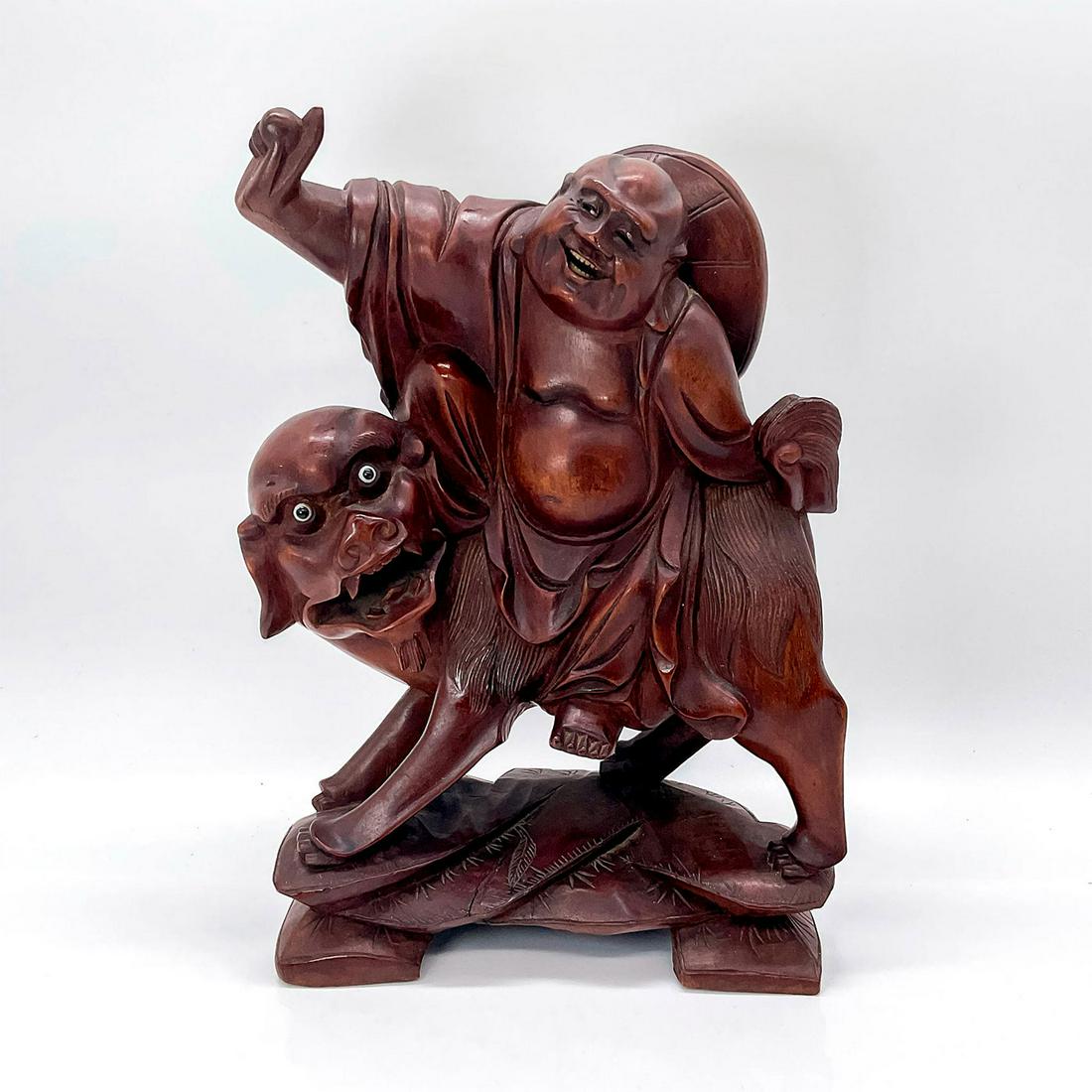 Chinese Rosewood Sculpture Laughing Buddha on Foo Dog: Finely hand-carved antique with superb detailed rosewood, depicting the Laughing Buddha, known as Budai Hotei, on the back of a recumbent Buddhist lion, Shishi or Foo Dog, wearing loosely draped robes