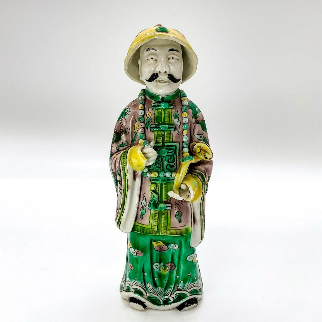 Chinese Famille Verte Figurine, Kangxi Emperor: Ceramic hand painted figure depicting the Emperor Kangxi in traditional clothing with a bead necklace around neck, holding a ru yi scepter. China marked to base. Issued: c. 1960 Dimensions: 2"W x 6"H