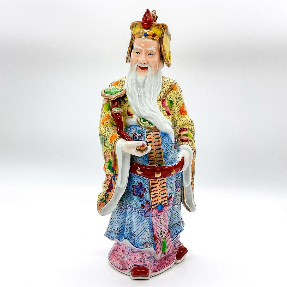 Chinese Porcelain Figure, Sanxing Deity: Hand painted figure, with gold gilt touches, of Shou god of longevity, in a detailed attire with peaches and flowers, carrying a ru yi scepter. Chinese character marks impressed to underside. Issued: 