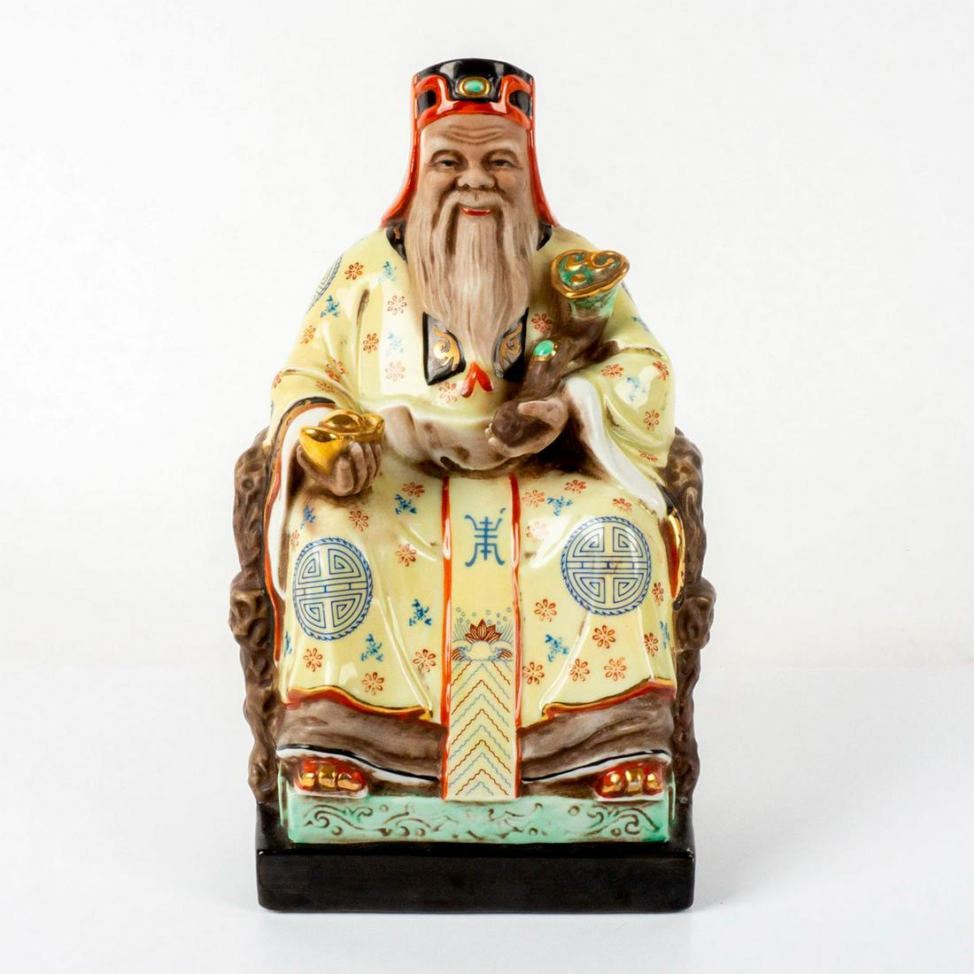 Chinese Porcelain Figurine, Tudigong: Splendid decorative piece of the earth god Tudigong seated on a throne holding a ru yi scepter and a large gilded ingot on each arm; gold gilt touches throughout. Issued: 20th c. Dimensions: 6"L x 5"W