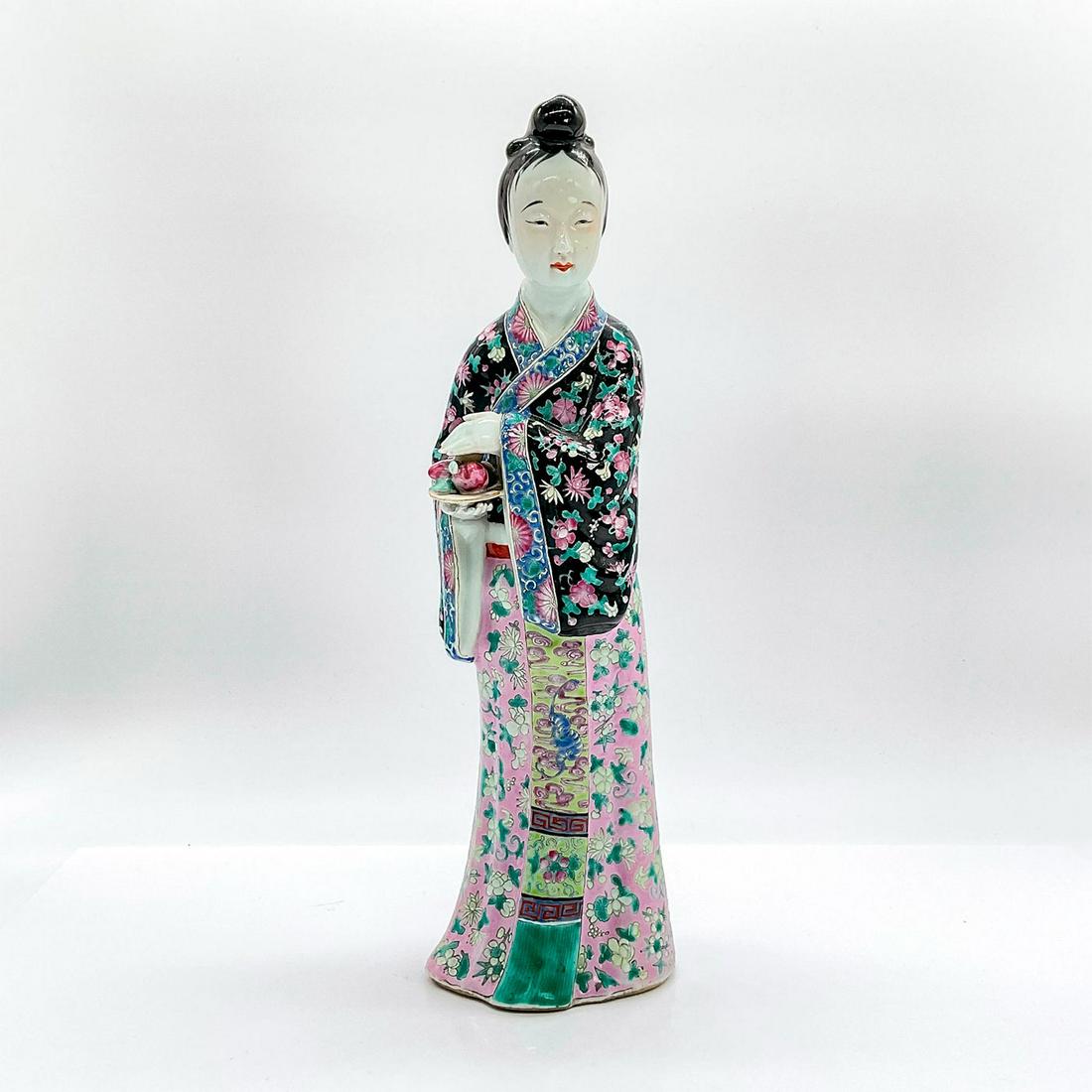 Vintage Chinese Figurine, Woman Holding Plums: Ceramic glazed figure of a standing lady in traditional colorful floral robe, holding a dish of plums. Dimensions: 3.5"L x 3"W x 12"H Country of Origin: China