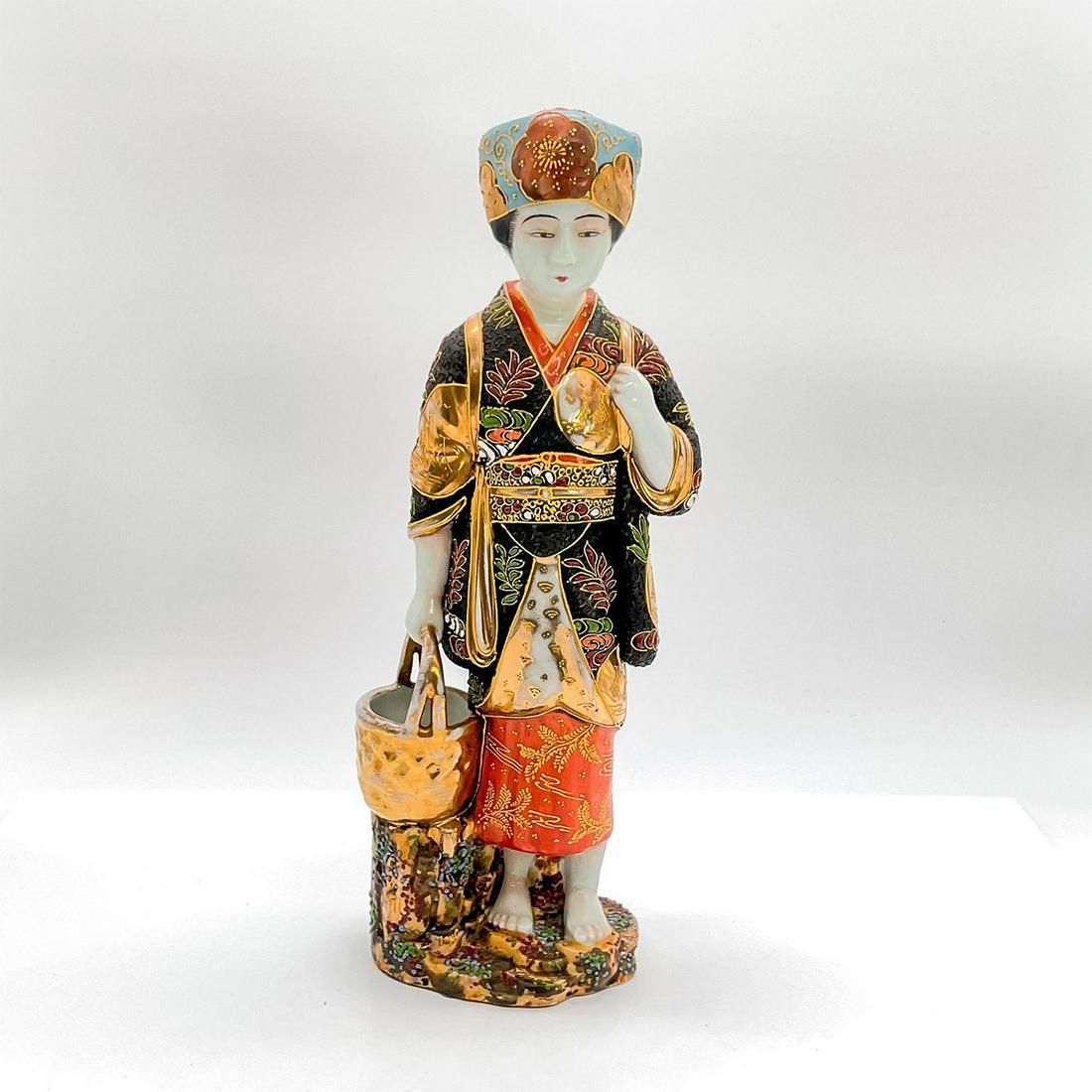 Vintage Japanese Figurine, Lady With Water Pail: Earthenware figure of a standing lady in blue hat, colorful robe, red skirt, holding a pail handle. Gold accents throughout. Dimensions: 4.25"L x 3"W x 12"H Country of Origin: Japan