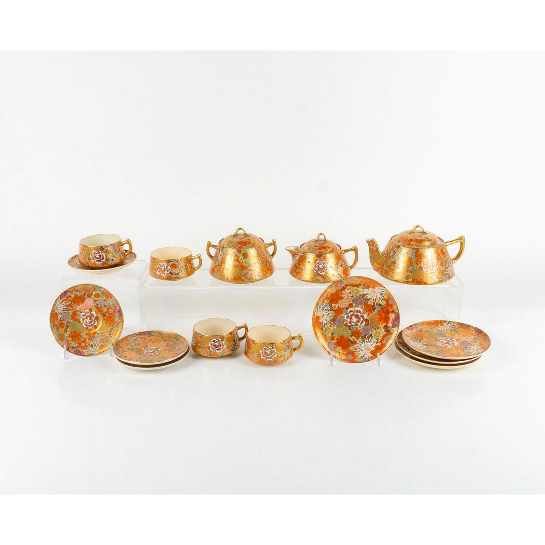 15pc Japanese Satsuma Millefleur Tea Set: Detailed floral design with heavy gilt. Four cups 3 in. D x 2 in. H, four saucers 5.25 in. D, four plates 6 in. D, lidded tea pot 7.5 in. L x 6 in. W x 4 in. H, lidded sugar bowl 5.5 in. L x 5 in. W x