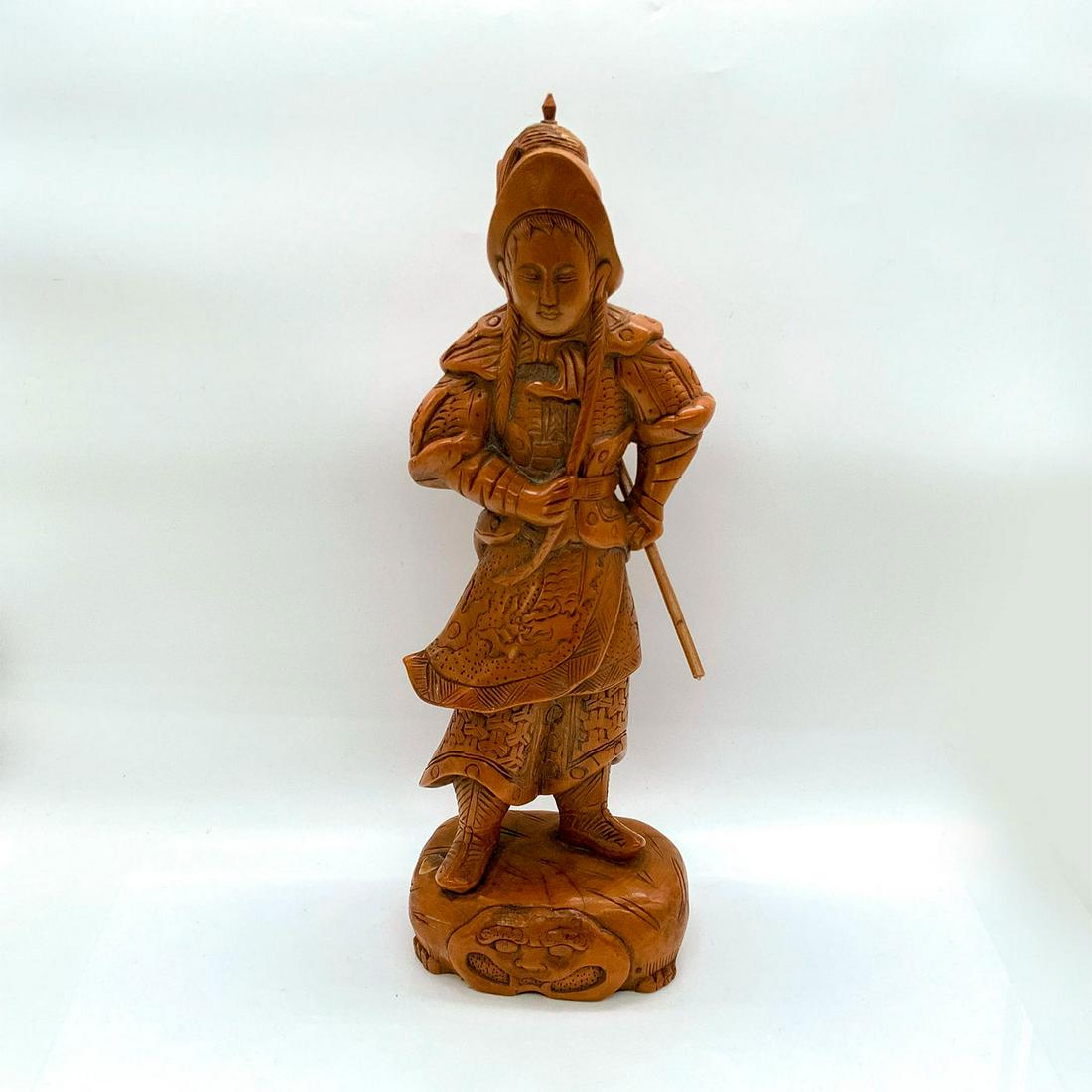Asian Wooden Sculpture, Warrior: Intricately detailed depicting soldier in uniform and holding weapon. Attached to wooden stand. Dimensions: 5.25"L x 4.75"W x 16.25"H