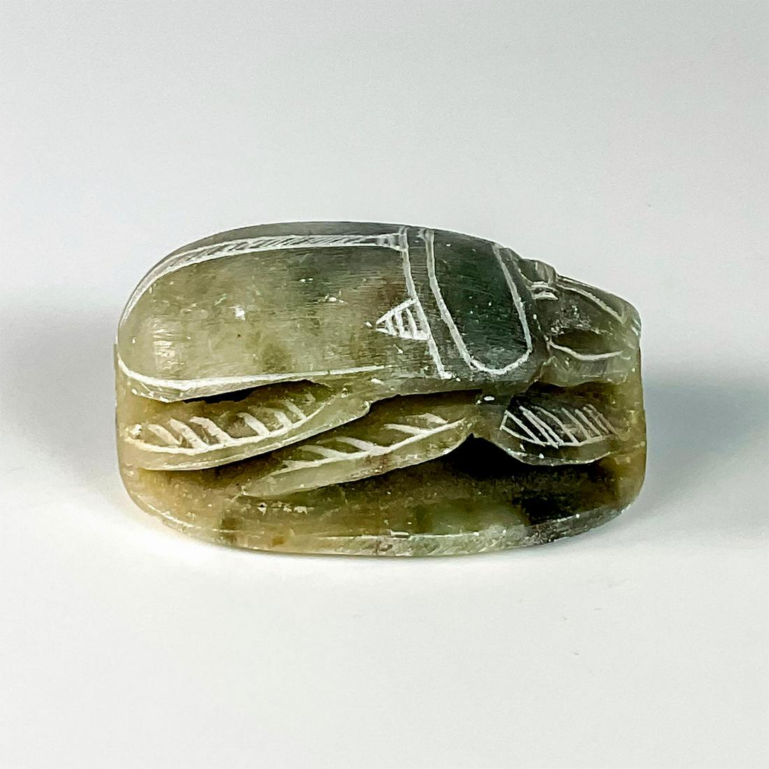 Green Carved Soapstone Figurine, Egyptian Scarab: Carved stone scarab with Egyptian hieroglyphics carved to base and incised details. Dimensions: 3"L x 2"W x 1.5"H