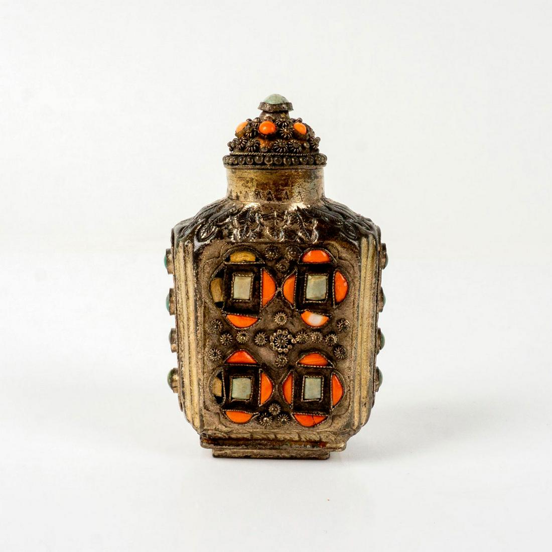 Vintage Indian Metal Snuff Bottle with Lid: Decorated with pink, green, and white stones and impressed acanthus design. 'China' impressed on the base Dimensions: 2"L x 1.5"W x 3"H Country of Origin: China
