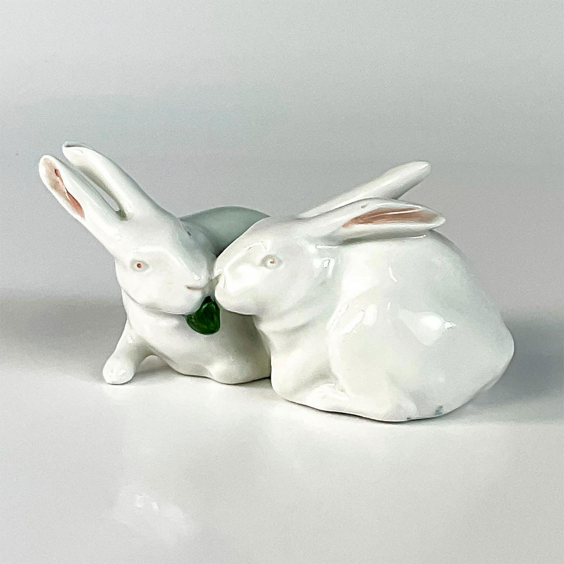 Royal Copenhagen Porcelain Figurine, Rabbits 518: Precious rabbits sharing a meal painted in white with pink ears and eyes. Marked Denmark, Initial KT on the bottom and the model number 518. Issued: Late 1900â€™s Dimensions: 4"L x 2.5"W x 1.75"H