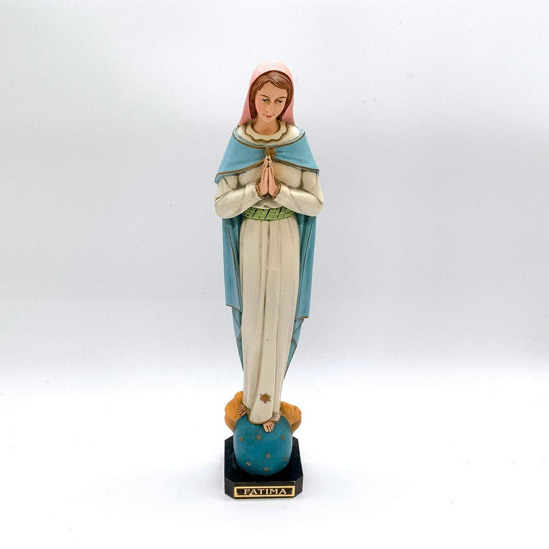 Our Lady of Fatima Resin Figurine: Depicts the Virgin Mary in standing pose wearing white gown and blue cape with hands clasped together in prayer. Attached to base. Dimensions: 2.5"L x 2"W x 11.5"H