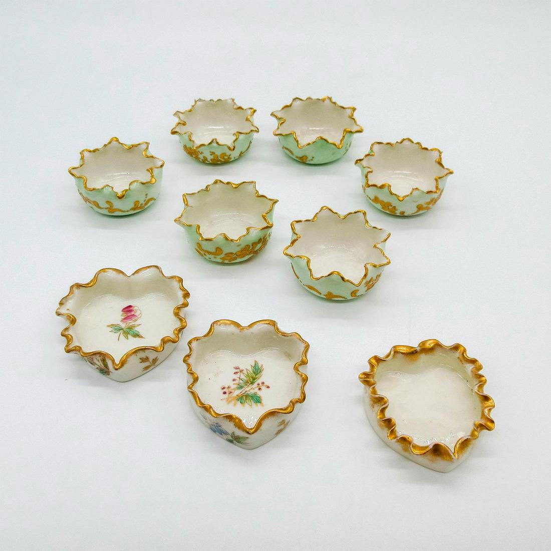 9pc Antique Belleek Willets China Pottery Salt Cellars: Beautiful floral painted salt cellars with gilded gold scalloped rims. Belleek Willets backstamps, Mint green: 0.75in x 1.75in. Floral heart: 2in x 2in x 0.5in. White heart: 1.75in x 1.75in x 0.5in. M