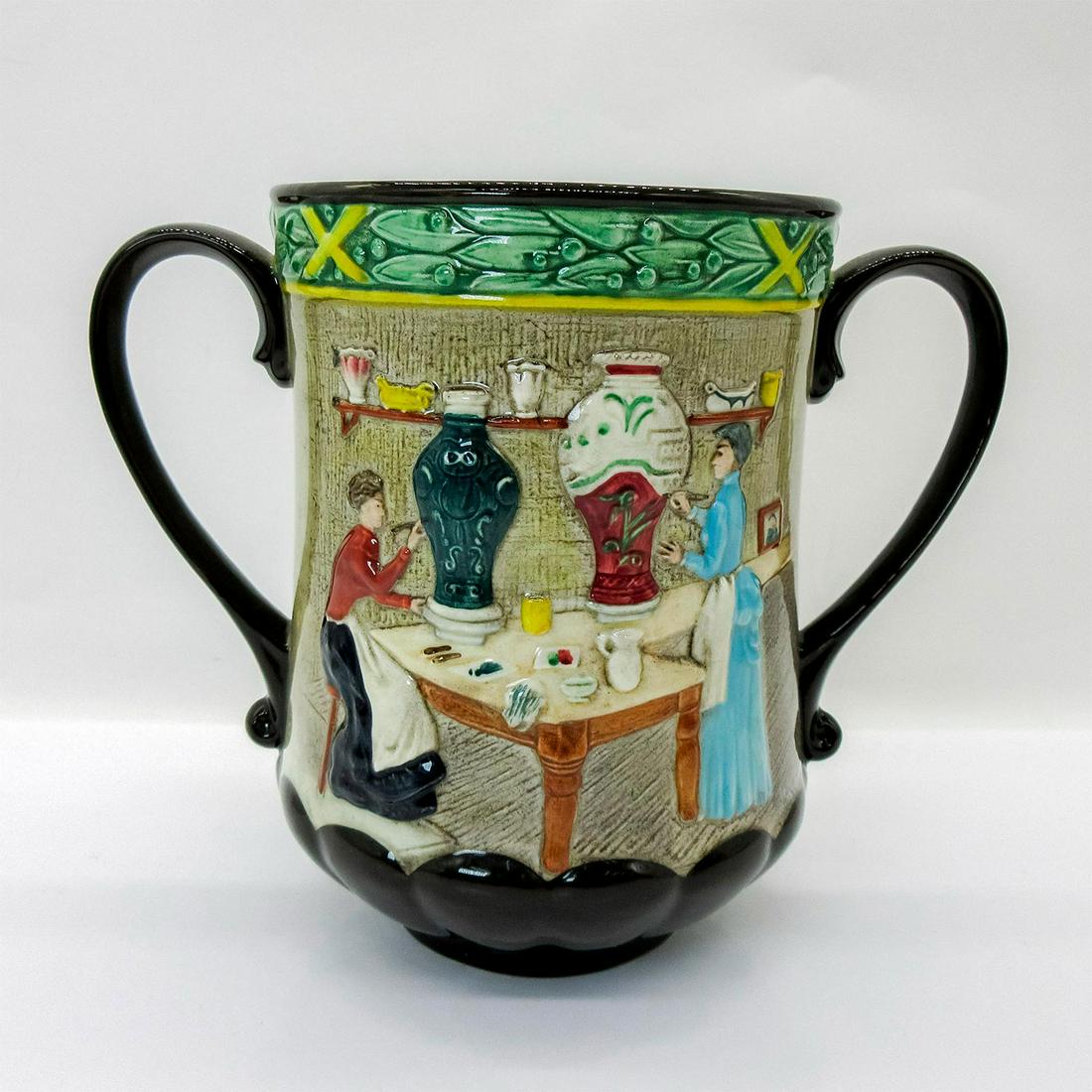 Royal Doulton Loving Cup, Pottery in the Past D6696: Large porcelain cup with depiction of women in their pottery studio in high-relief. Exclusive for Royal Doulton International Collectors Club. Royal Doulton backstamp. Issued: 1982 Dimensions: 6.25"H 