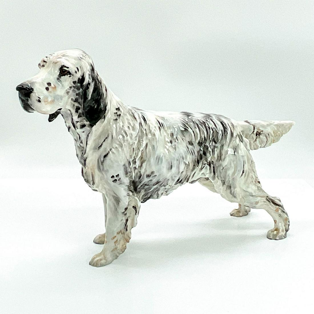 Royal Doulton Dog Figurine, English Setter, Maesydd Mustard: HN1049, white, grey and black dog standing with an alert, focused gaze. Royal Doulton backstamp. Issued: 20th c. Dimensions: 12"L x 3.25"W x 7.75"H Manufacturer: Royal Doulton Country of Origin: Engla