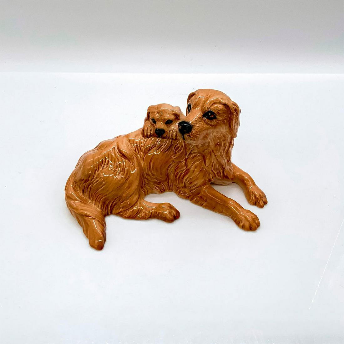 Royal Doulton Animal Figurine, Retriever and Pup DA173: Glossy finish. In golden brown coloration. Royal Doulton backstamp. Artist: Warren Platt Issued: 1992-1997 Dimensions: 6.25"L x 4.75"W x 3.25"H Manufacturer: Royal Doulton Country of Origin: Engla