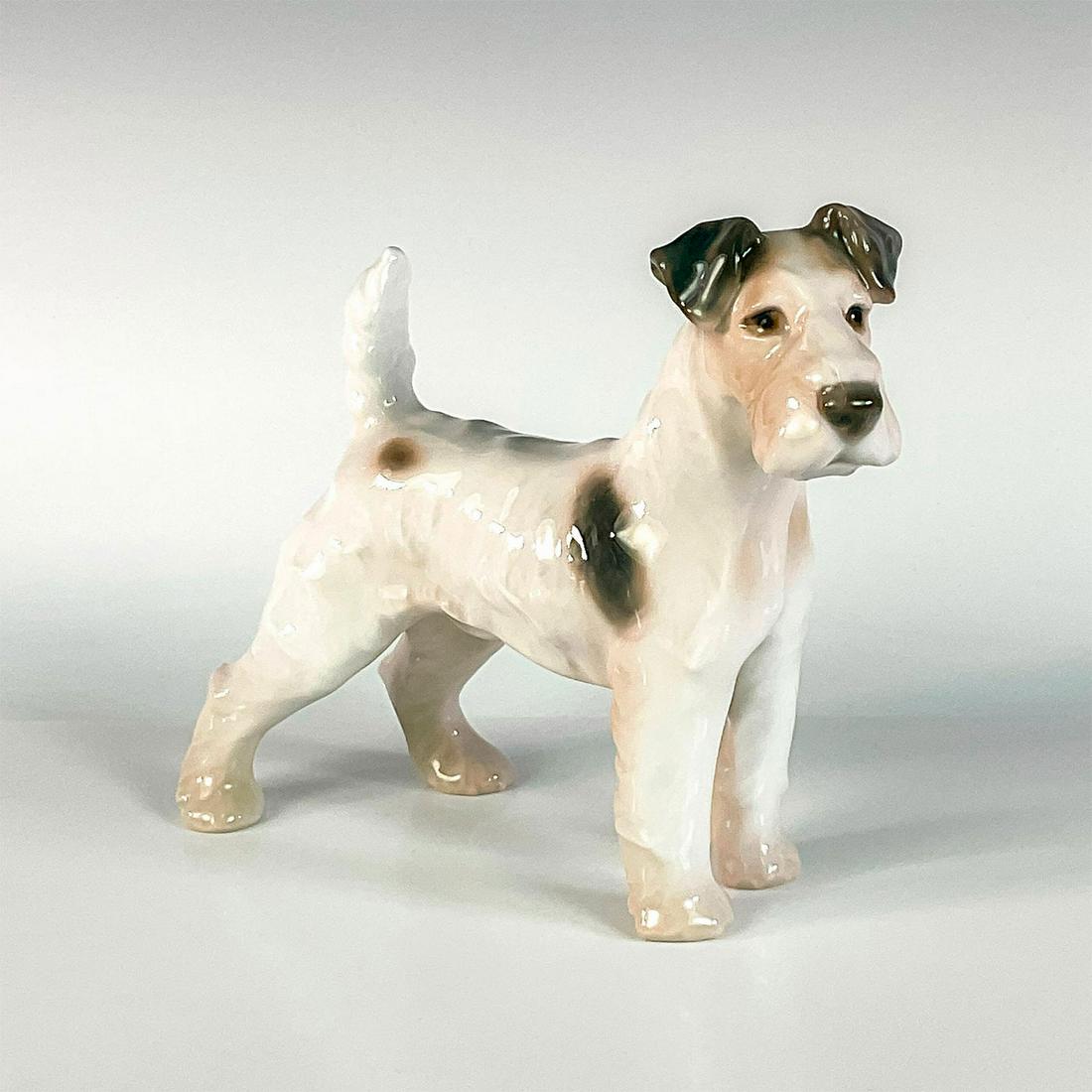 Vintage Bing & Grondahl Figurine, Fox Terrier: Glossy finish. In white, with tan and brown coloration. B&G backstamp. Dimensions: 6"L x 2.5"W x 5.5"H Manufacturer: Bing & Grondahl Country of Origin: Denmark