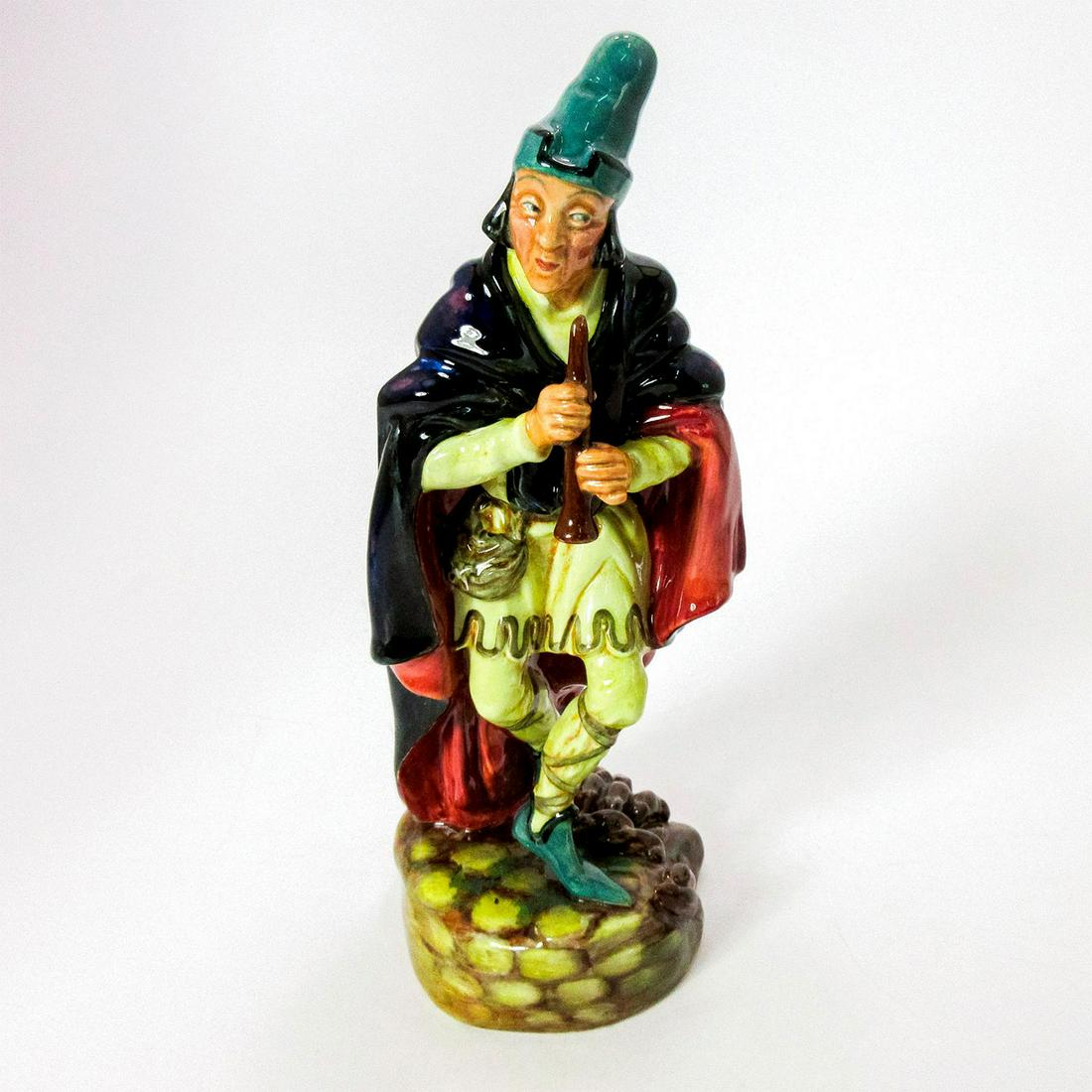 Pied Piper HN2102 - Royal Doulton Figurine: Harradine Classics series. Man playing flute, wearing polychrome cloak over yellow outfit. Royal Doutlon backstamp. Artist: Leslie Harradine Issued: 1953 - 1976 Dimensions: 8.75"H Manufacturer: Royal 