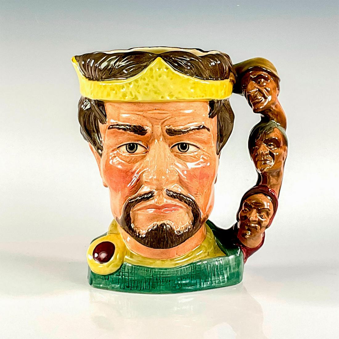 Macbeth D6667 - Large - Royal Doulton Character Jug: Brown, yellow and green coloration. The faces of the three witches on the outer side of the handle face outward (noses out). Only after the jug was in the initial stages of production did Doulton real