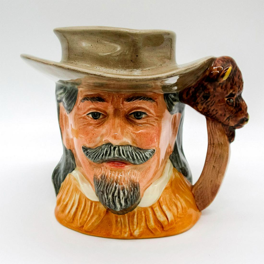 Buffalo Bill D6735 - Odd Size - Royal Doulton Character Jug: Light brown hat and buckskin jacket. William Frederick Cody (1846 - 1917) was a scout, plainsman, soldier in the Civil War, hotelier, rancher and showman. His expert marksmanship as a buffalo hunter e