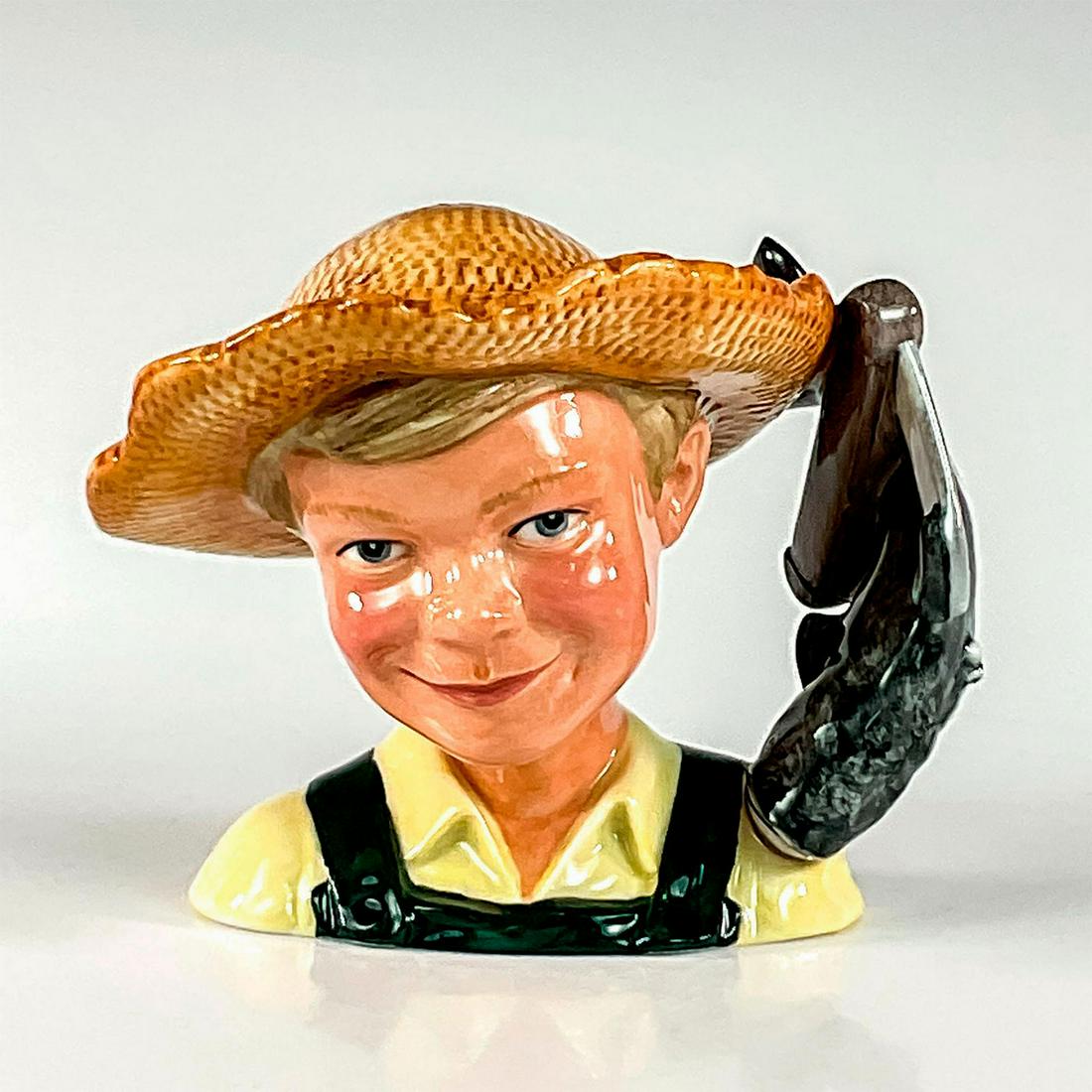 Huckleberry Finn D7177 - Small - Royal Doulton Character Jug: White shirt; green overalls; straw hat. Series: ICC. Royal Doulton and ICC backstamp. Artist: Shane Ridge Issued: 2002 - 2002 Dimensions: 5.25"H Manufacturer: Royal Doulton Country of Origin: