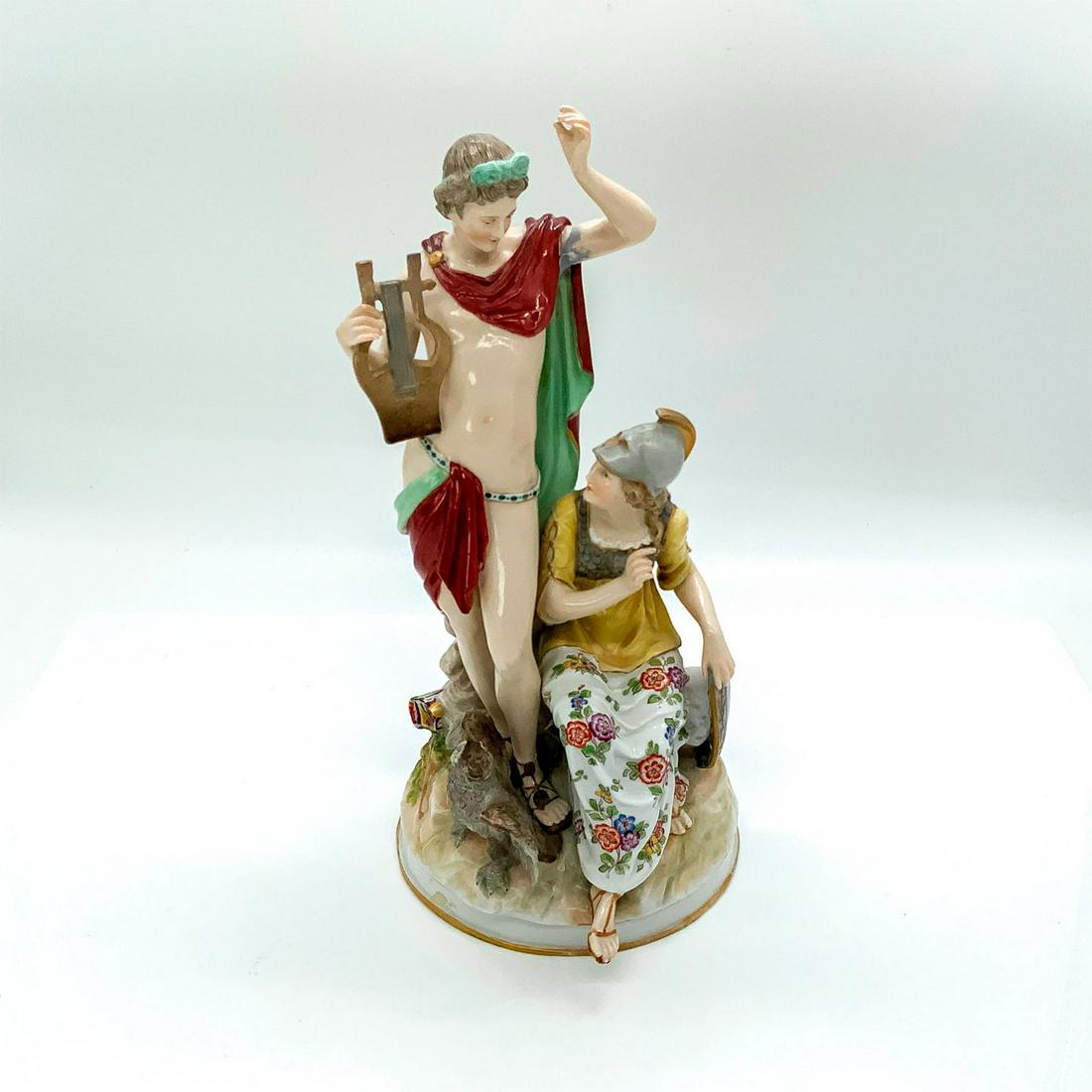 Antique Hochst Porcelain Figural Grouping: Hand decorated figure dpicting Apollo holding his lyre, seated Minerva, Cupid and a quiver of arrows, and an owl with outstretched wings. Hochst backstamp on base. Dimensions: 12" H Manufacturer: Hoch