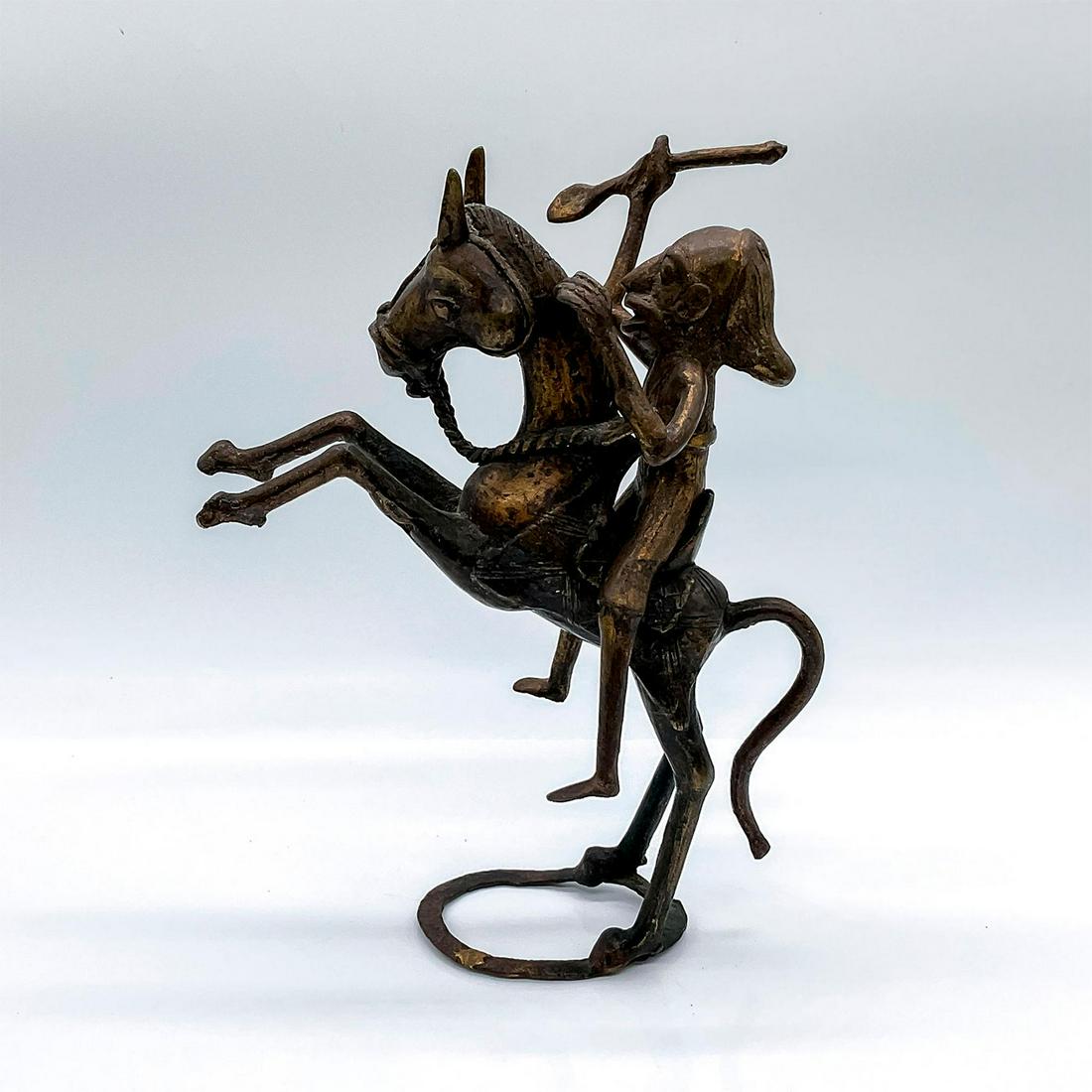 Vintage African Gilded Bronze Figural Sculpture: A figure of a man holding a spear, hunting on horseback. The man is detachable from the horse. Dimensions: 7.25"L x 4.5"W x 9"H Country of Origin: Africa